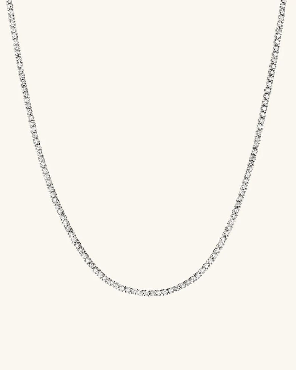 Silver chain necklace on a light gray background