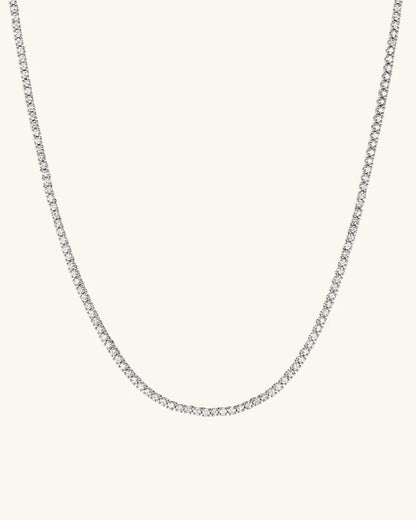 Silver chain necklace on a light gray background