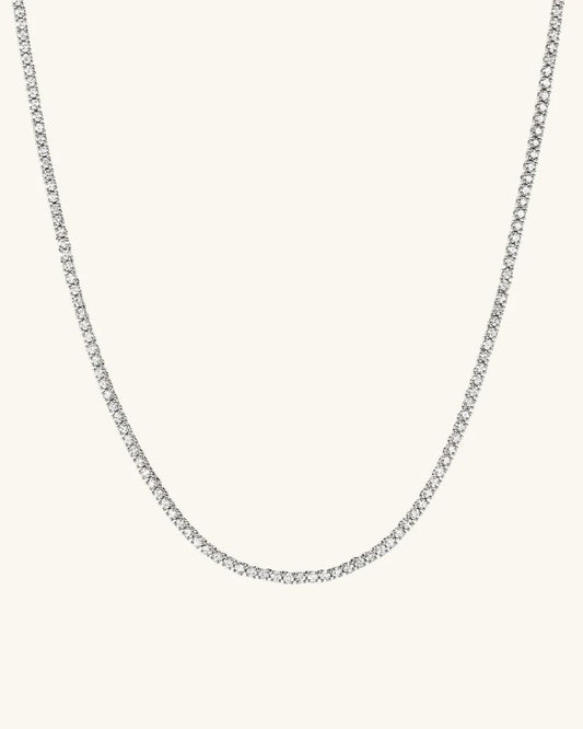 Silver chain necklace on a light gray background